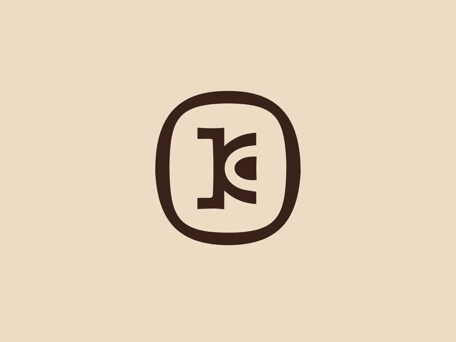 The Kunoa logo features a stylized, capital letter "K" enclosed within an oval border. The "K" is comprised of a solid vertical line intersected by two right-angled lines that suggest the letter's diagonal strokes. The design has a bold, contemporary feel with its clean lines and lack of additional embellishment, giving it a professional and modern aesthetic. The logo utilizes a rich, dark brown color that conveys a sense of reliability and groundedness. Considering the color scheme and the simplicity of the design, a subtle background color would complement this logo well.