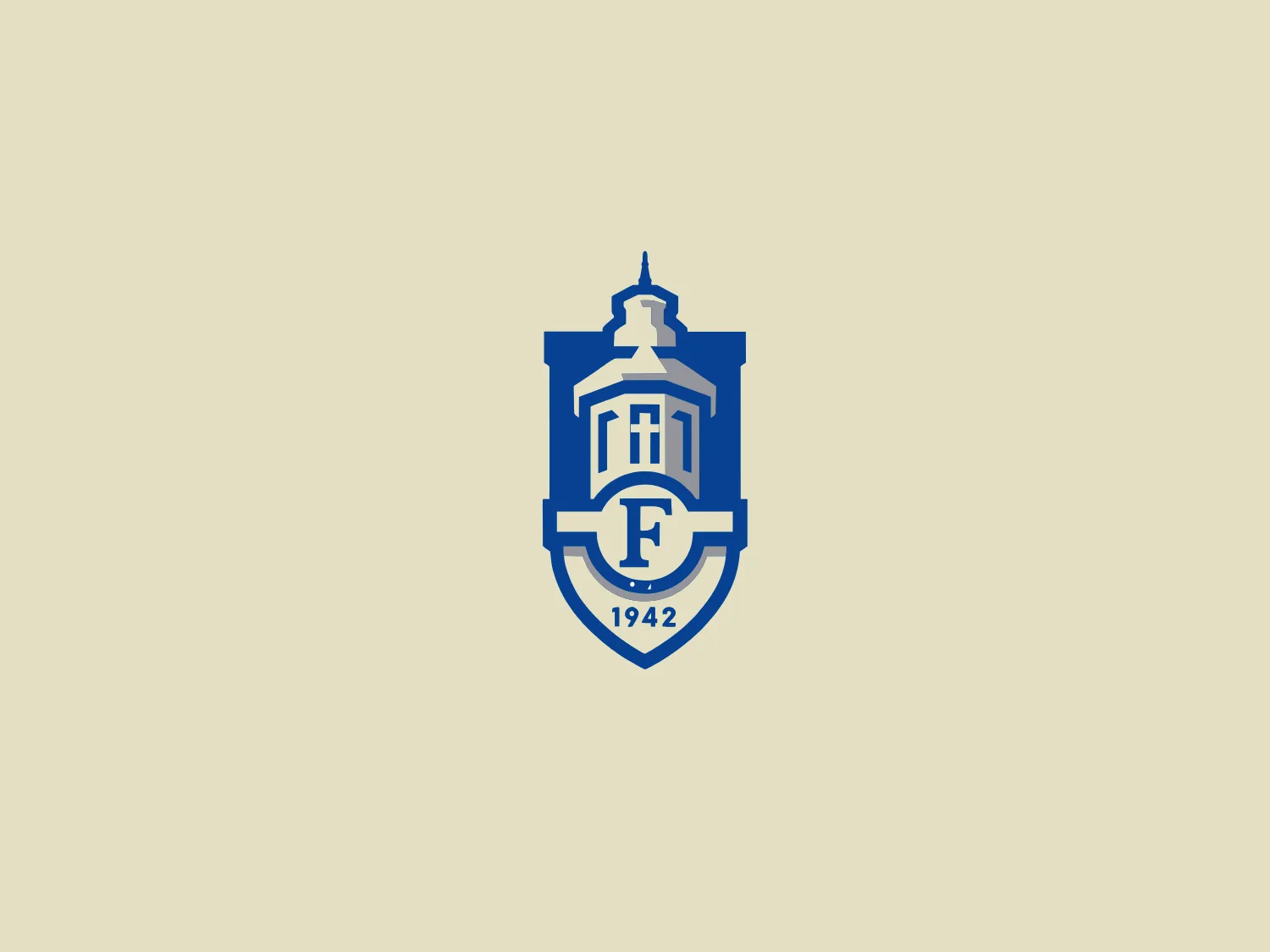 The Faulkner University emblem is a stylized shield shape in deep blue, showcasing a classical building with a prominent cupola on top. Overlaid on the building are the capitalized letters "F" and "H," representing the institution's initials. Below the building, the year "1942" is inscribed within a banner, reflecting the establishment date of the organization. This logo combines tradition and solidity, evoking a sense of educational or governmental institutional heritage.